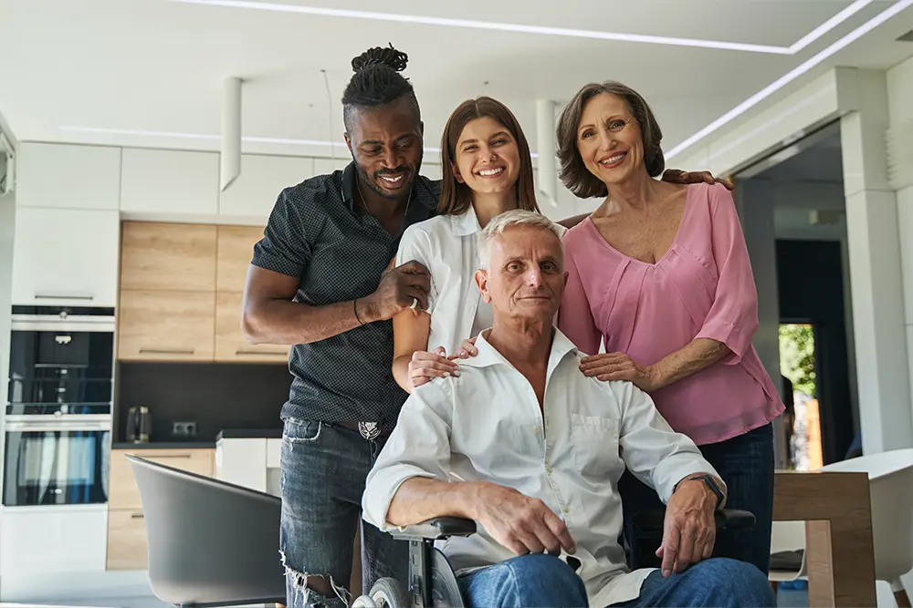 Group of people supporting a man with a disability, symbolizing digital inclusion and accessibility online